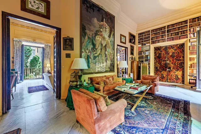 a living room with furniture fireplace and a window