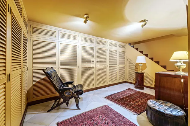 a view of a bedroom with a table and chairs