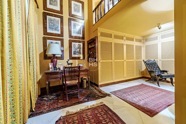 a spacious bedroom with a bed and wooden floor