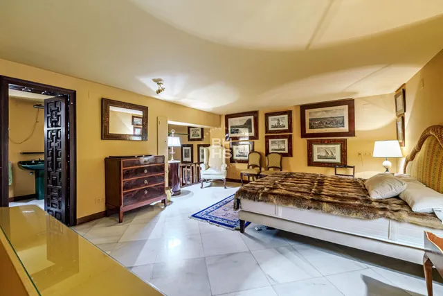 a bedroom with a bed couch and a window