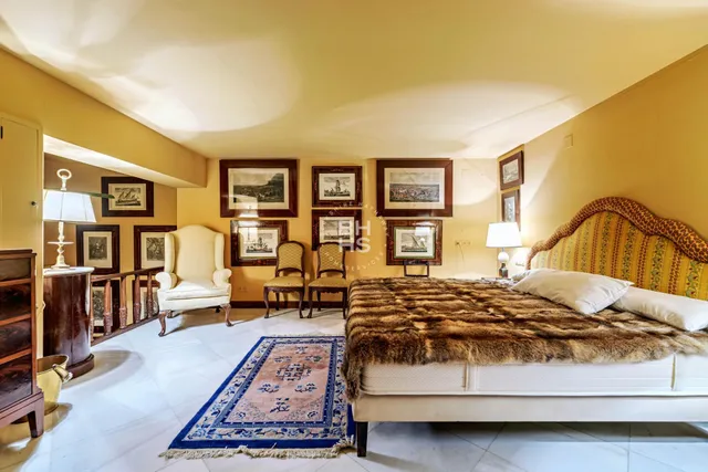 a bedroom with a large bed and a couch