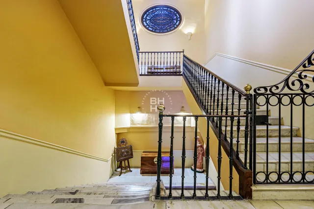 a backyard of a house with sofas table and chairs