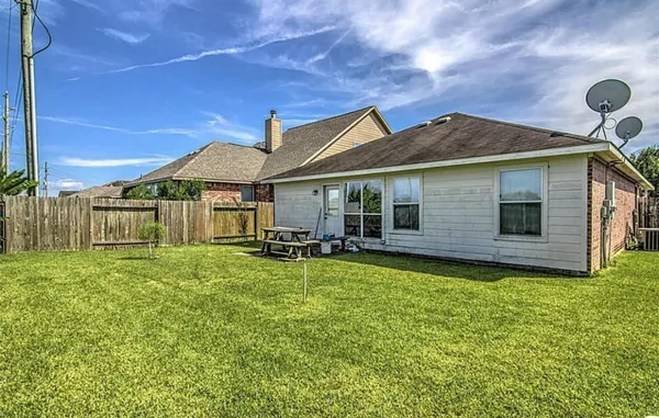 a backyard of a house with table and chairs