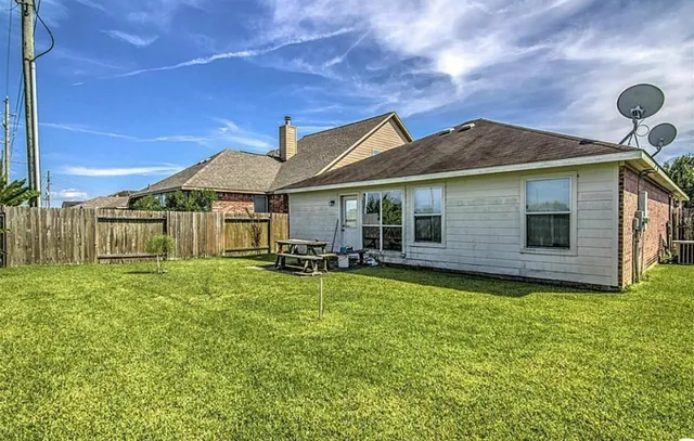 a backyard of a house with table and chairs