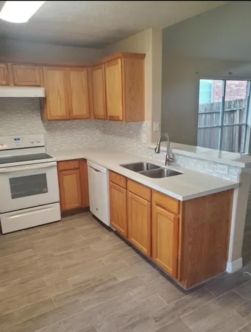 a kitchen with a sink stove and cabinets