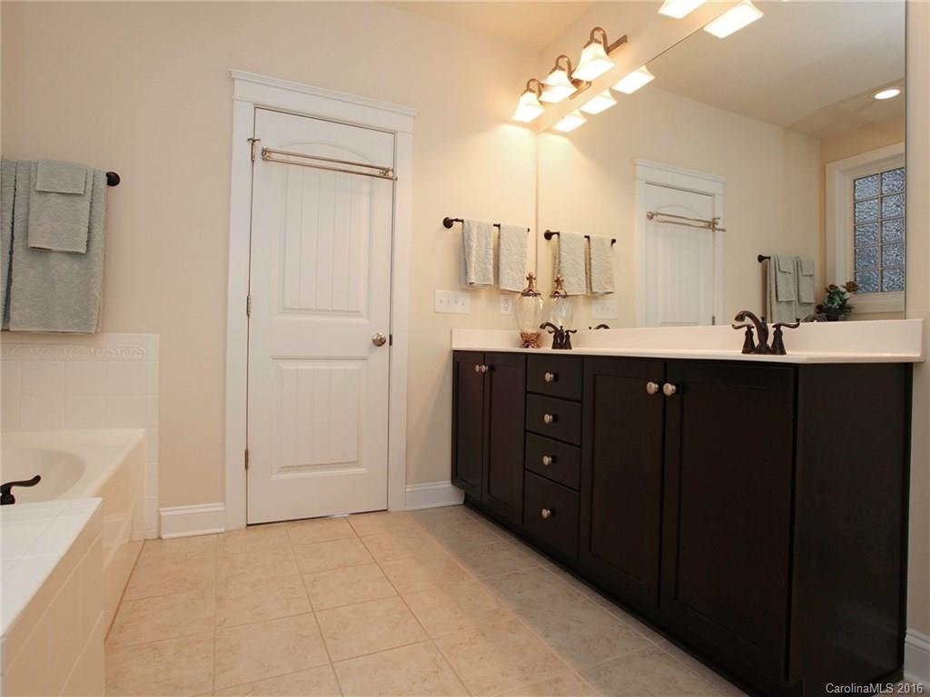 660 Revival Row Fort Mill, SC 29708 - Photo 16 of 24 a spacious bathroom with a double vanity sink a mirror and a bathtub