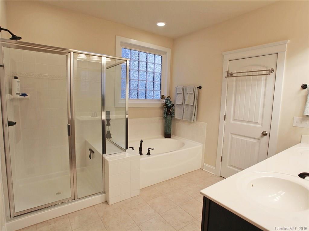660 Revival Row Fort Mill, SC 29708 - Photo 17 of 24 a bathroom with a tub a sink and a large mirror
