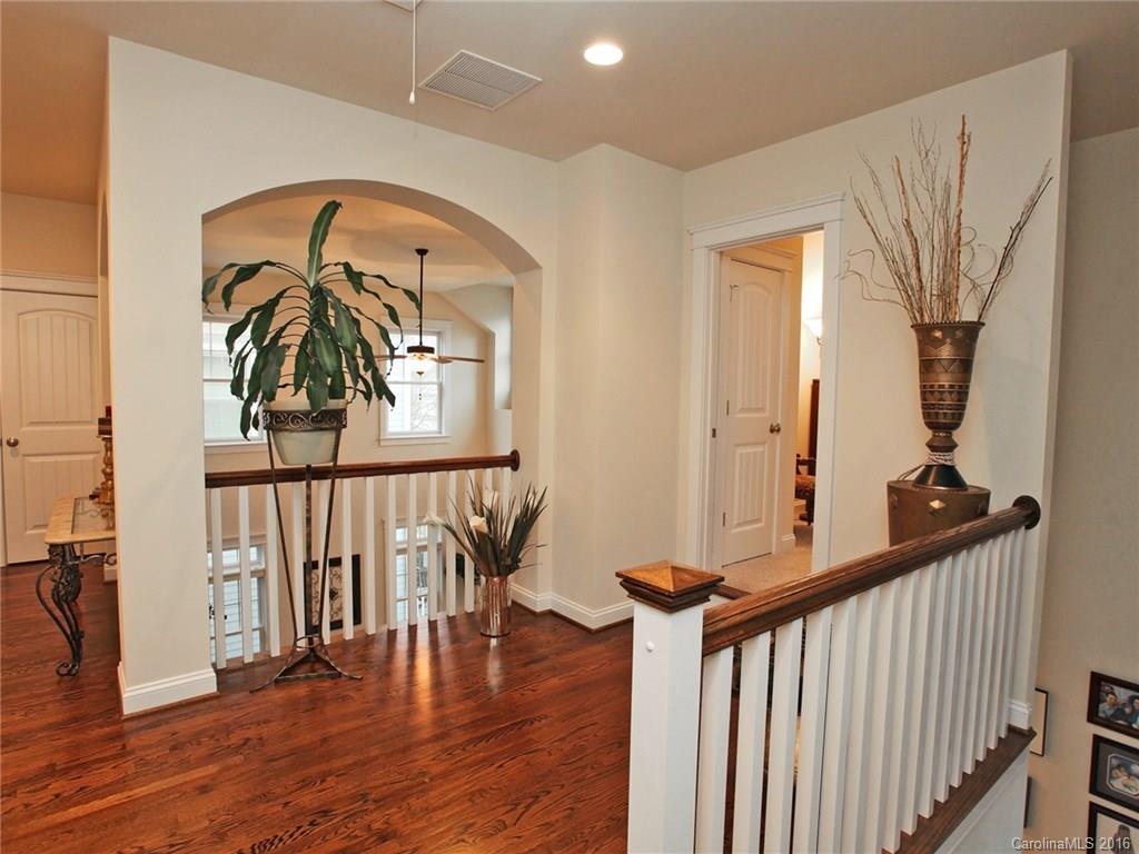 660 Revival Row Fort Mill, SC 29708 - Photo 18 of 24 a view of a hallway with wooden floor and stairs