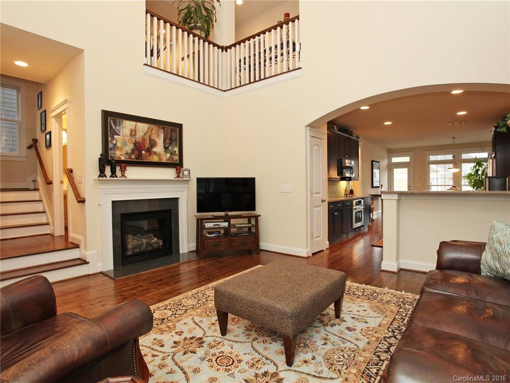 660 Revival Row Fort Mill, SC 29708 - Photo 6 of 24 a living room with furniture a flat screen tv and a fireplace