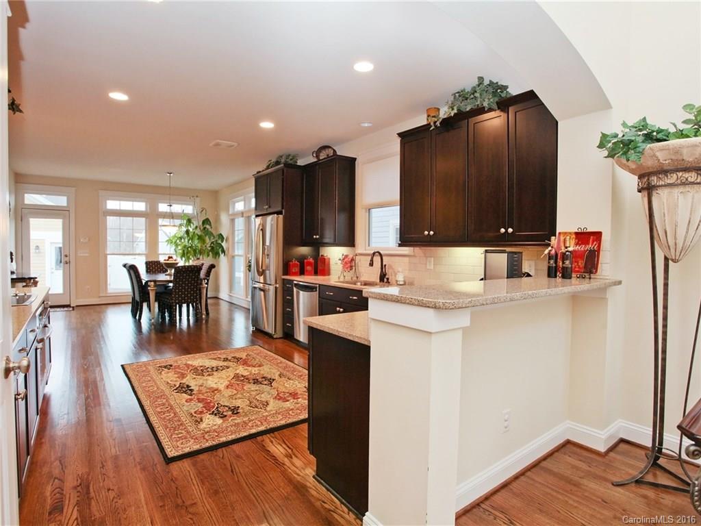 660 Revival Row Fort Mill, SC 29708 - Photo 8 of 24 a kitchen with stainless steel appliances granite countertop a refrigerator dining table and chairs