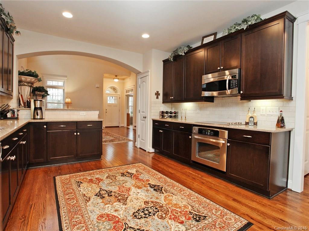 660 Revival Row Fort Mill, SC 29708 - Photo 10 of 24 a large kitchen with stainless steel appliances and a stove top oven