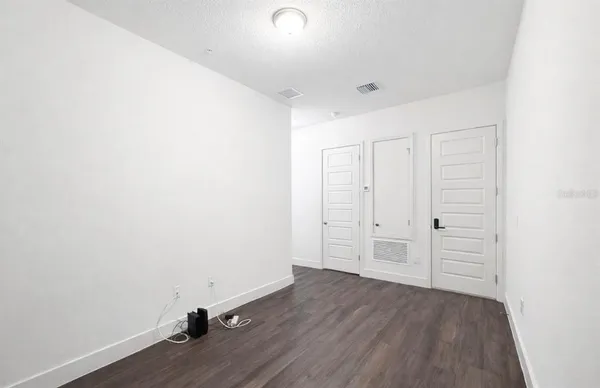 a view of a room with wooden floor