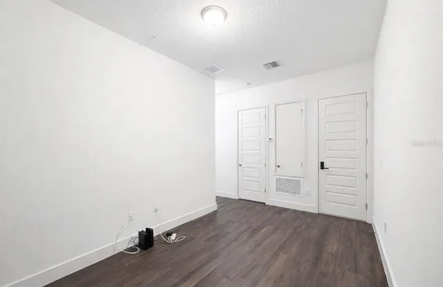 a view of a room with wooden floor