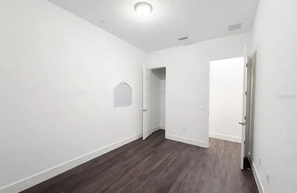 a view of a room with wooden floor