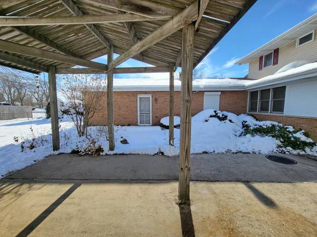 a view of a patio with table and chairs potted plants