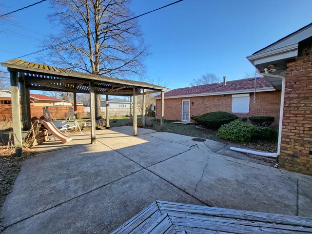 a spacious bedroom with a bed and a window
