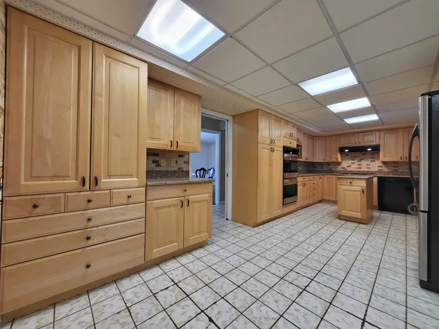 a room with a refrigerator and a sink