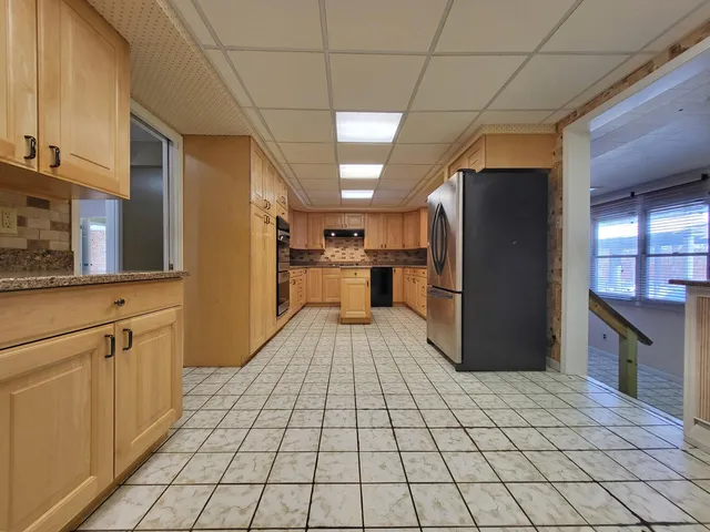 a kitchen with stainless steel appliances granite countertop a refrigerator sink and cabinets