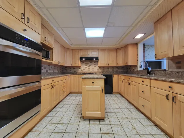 a kitchen with white cabinets and a sink