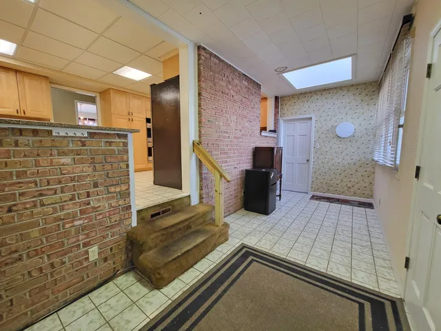 a spacious bathroom with a double vanity sink a mirror and a shower