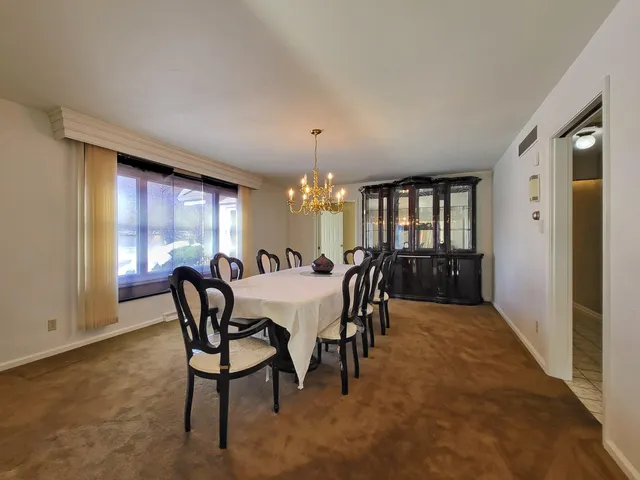 a dining room with furniture and window