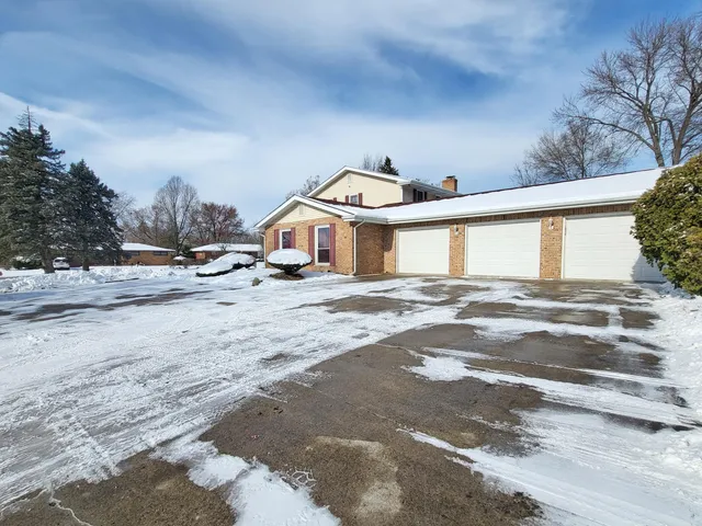 a view of a house with a snow on the road