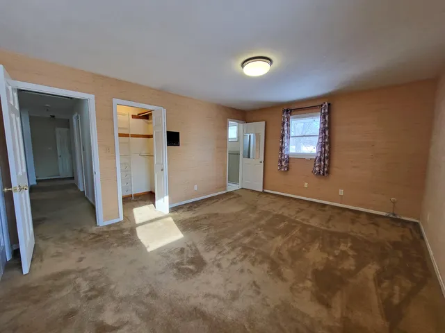 a spacious bathroom with a double vanity sink a mirror and a shower