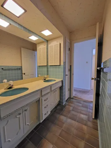 a room with a bed and cabinets