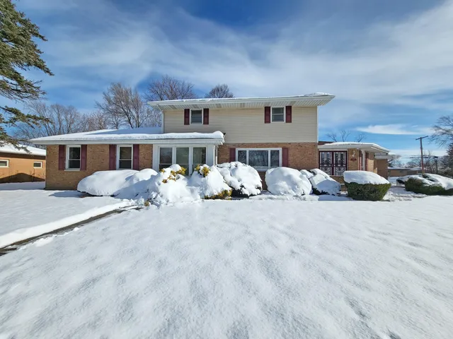 a view of a house with a yard and sitting area