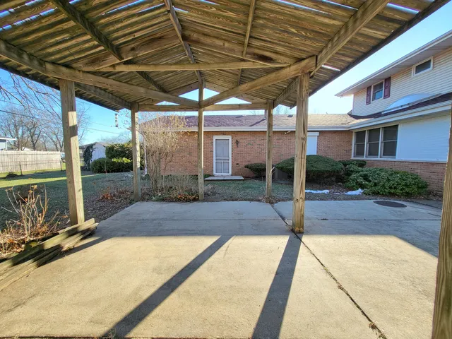 a big room with windows and a dresser