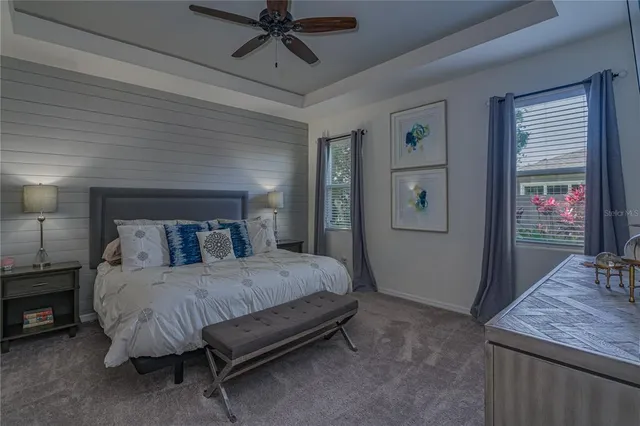 a bedroom with a bed a table and painting