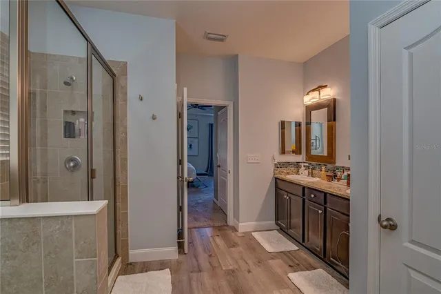 a bathroom with a mirror sink and shower