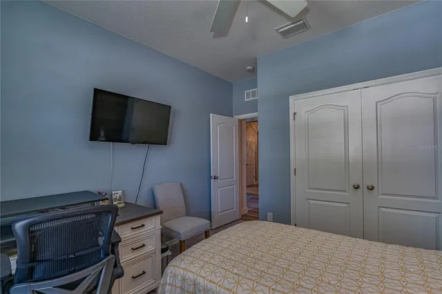 a bedroom with a bed and a flat screen tv