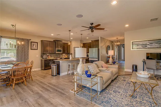 a living room with furniture and kitchen view