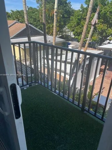 an empty room with a fan & a window