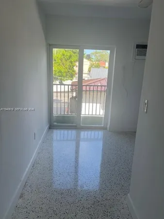 en empty room with windows and fan