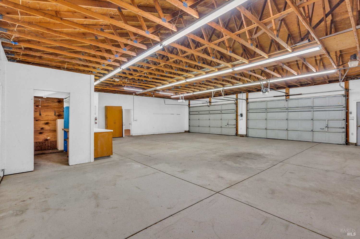 7562 Paddon Road Vacaville, CA 95688 - Photo 59 of 91 interior commercial garage showing parking/area, storage area, counter to office and entry to ADU