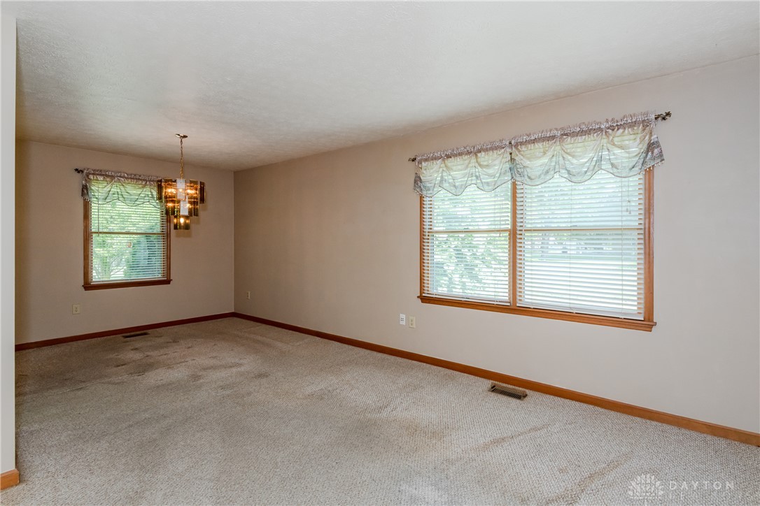 5709 Preble County Line Road Lewisburg, OH 45338 - Photo 16 of 47 This living area features a classic ceiling fixture and windows offering natural light.