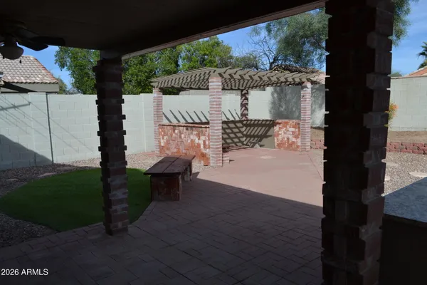 a front view of house with yard and trees in the background