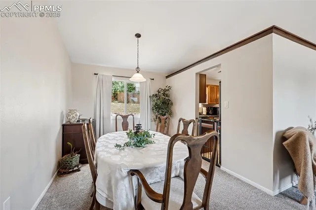 a view of a dining room with furniture and window