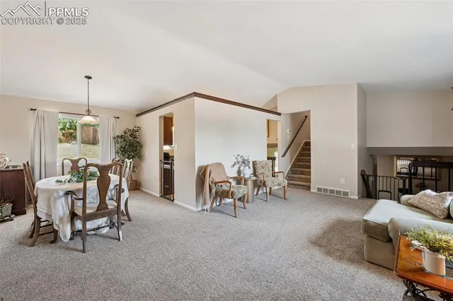 a view of a livingroom with furniture and a window