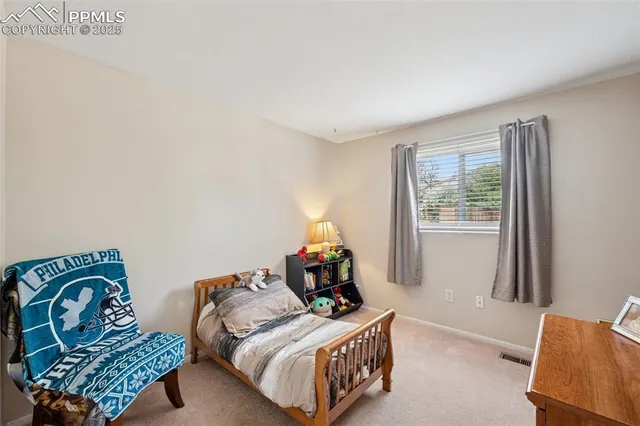 a bedroom with two beds and a window