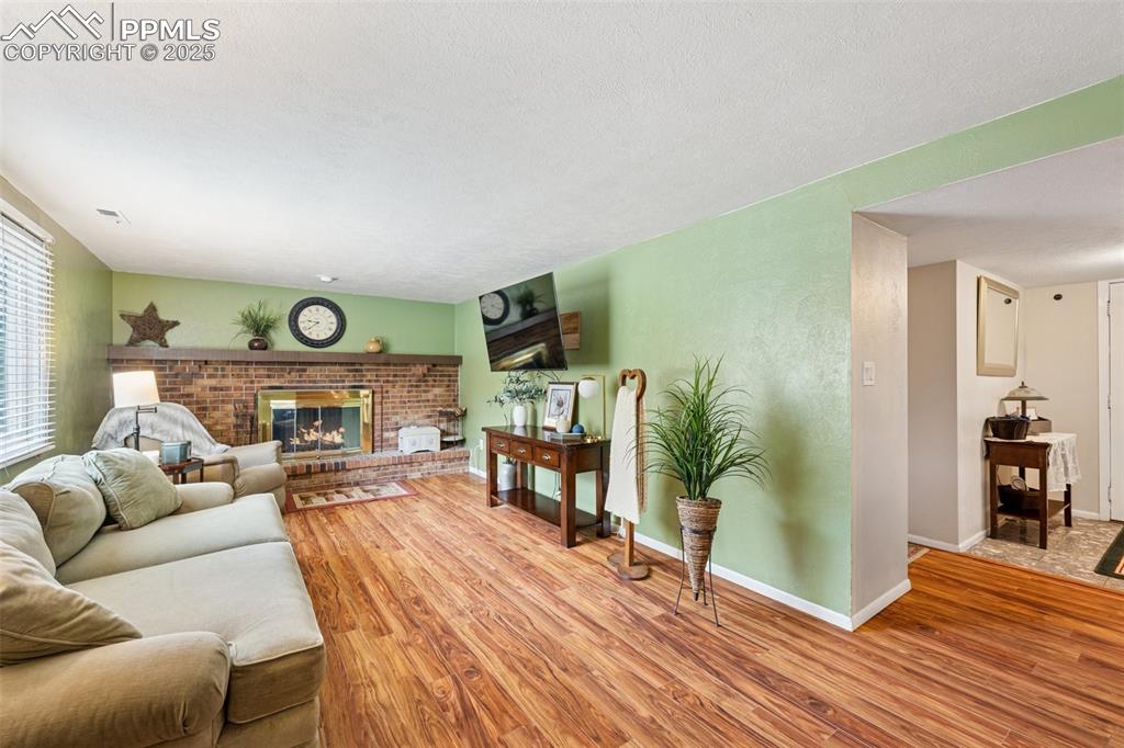 5560 Constitution Avenue Colorado Springs, CO 80917 - Photo 2 of 30 a living room with furniture and a wooden floor