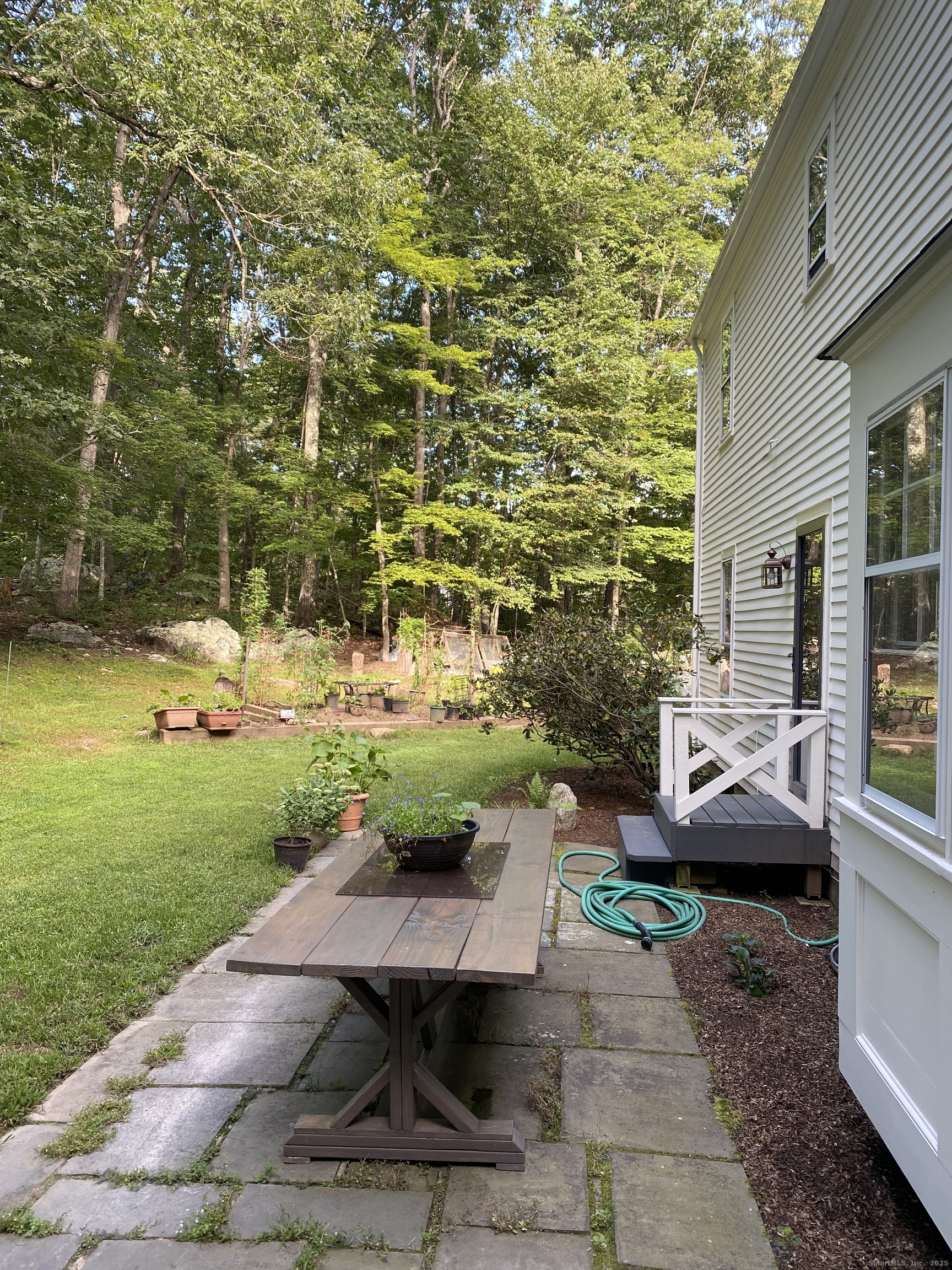 61 High Rock Road Newtown, CT 06482 - Photo 14 of 14 a view of a patio with table and chairs and potted plants