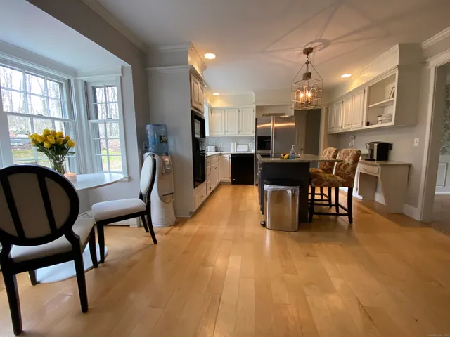 a view of a dining room with furniture and chandelier