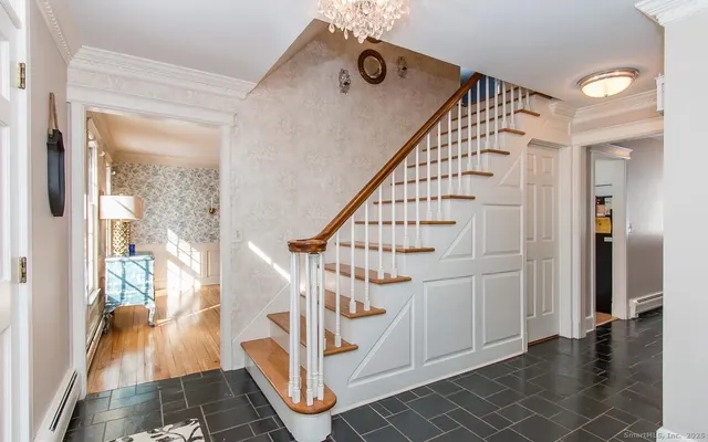 a view of entryway and hall with wooden floor