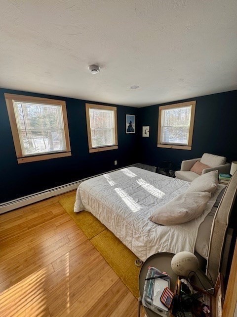 26 Highland Street Mashpee, MA 02649 - Photo 11 of 20 a bedroom with a bed and wooden floor
