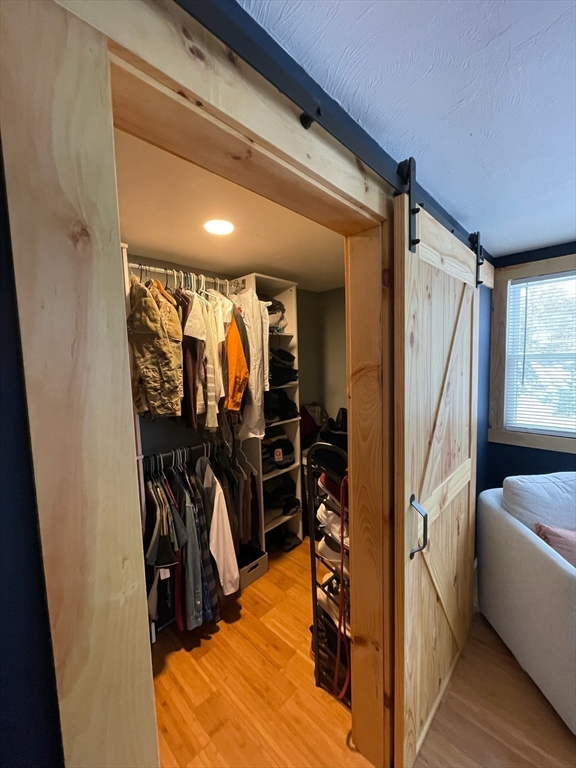 26 Highland Street Mashpee, MA 02649 - Photo 12 of 20 a view of walk in closet with clothes and shoes