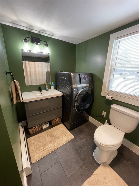 26 Highland Street Mashpee, MA 02649 - Photo 13 of 20 a bathroom with a toilet sink and mirror