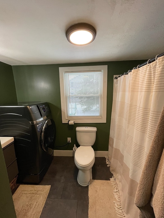 26 Highland Street Mashpee, MA 02649 - Photo 14 of 20 a bathroom with a toilet sink and mirror